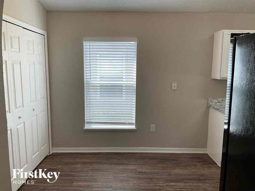 a small room with a refrigerator and a window