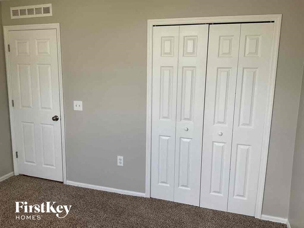 a pair of closets with white doors and a carpet