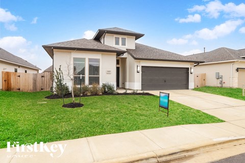 A house with a sign in front of it that says "Firstkey".