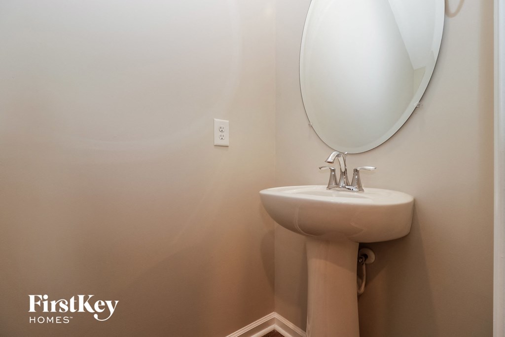 a small bathroom with a sink and a mirror