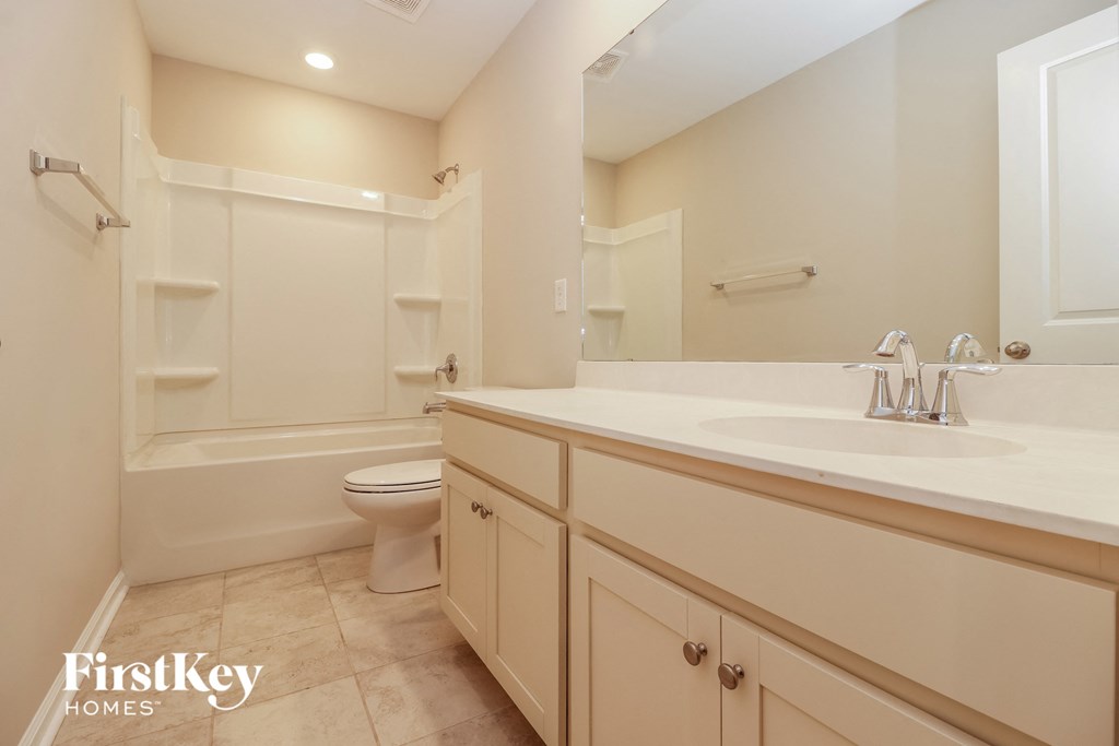 a bathroom with a sink and a toilet and a bath tub