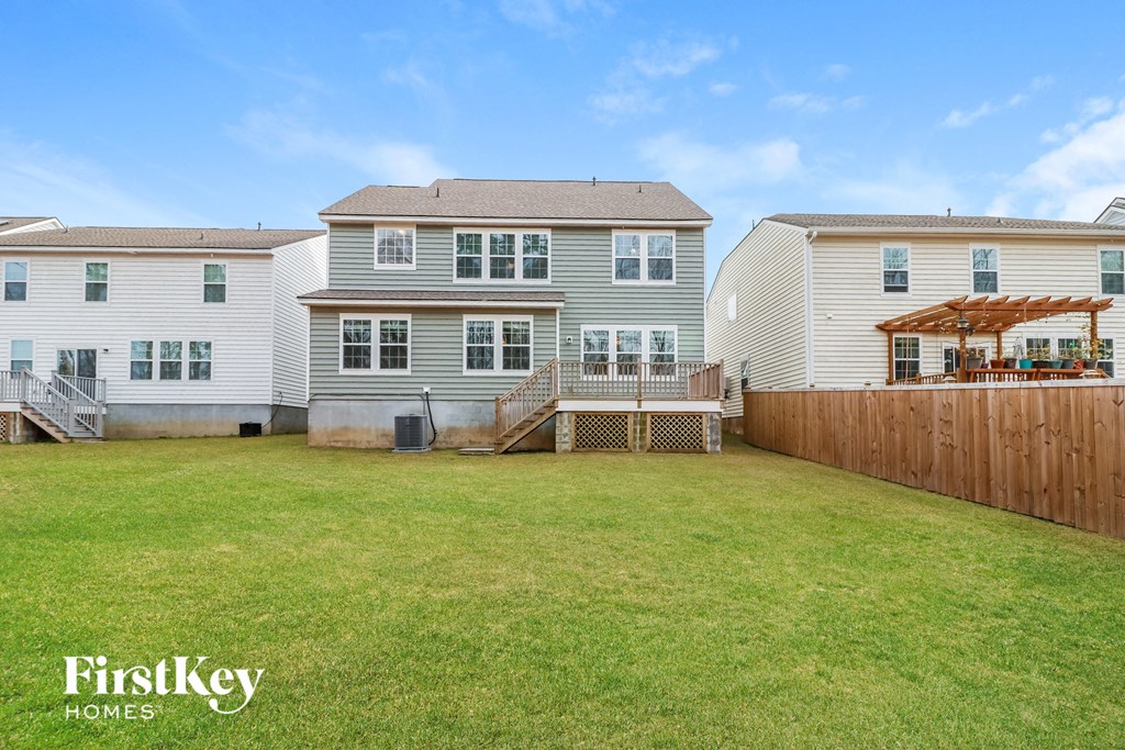 a backyard with three houses and a fence
