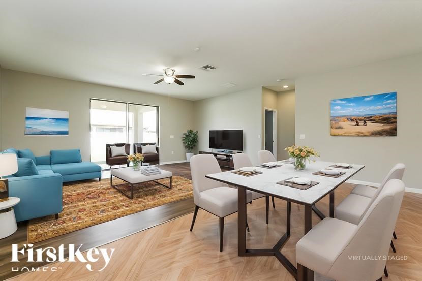 A modern dining room with a glass table and chairs.