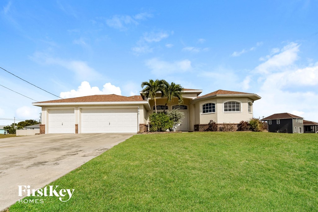 a house with a lawn and a white garage door