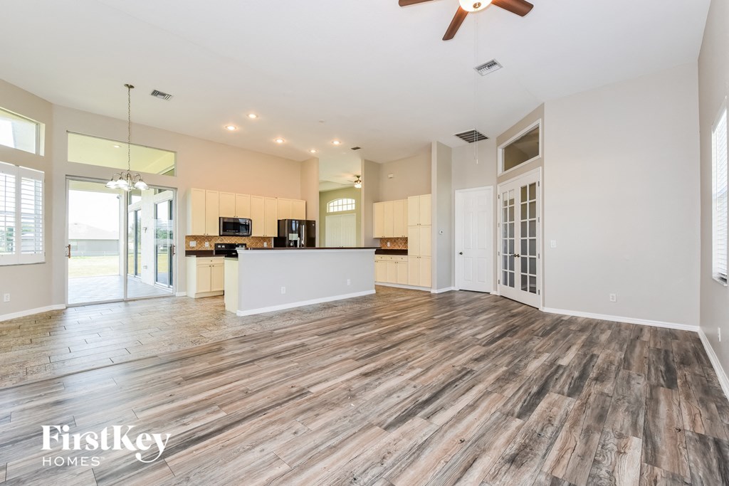 the living room and kitchen are open to the dining room and the pool area