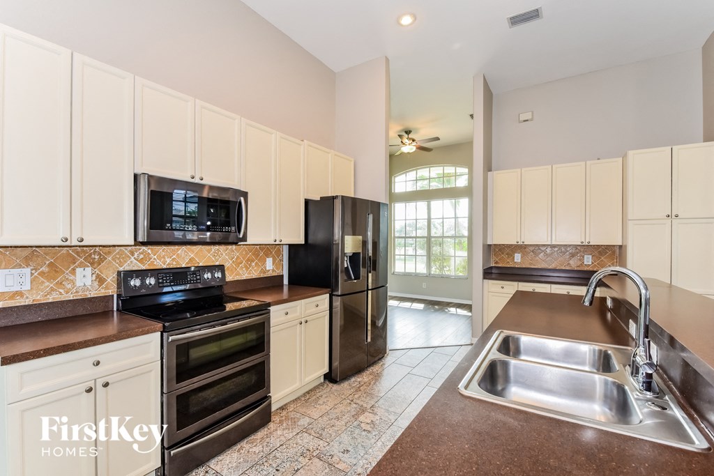 a kitchen with stainless steel appliances and white cabinets
