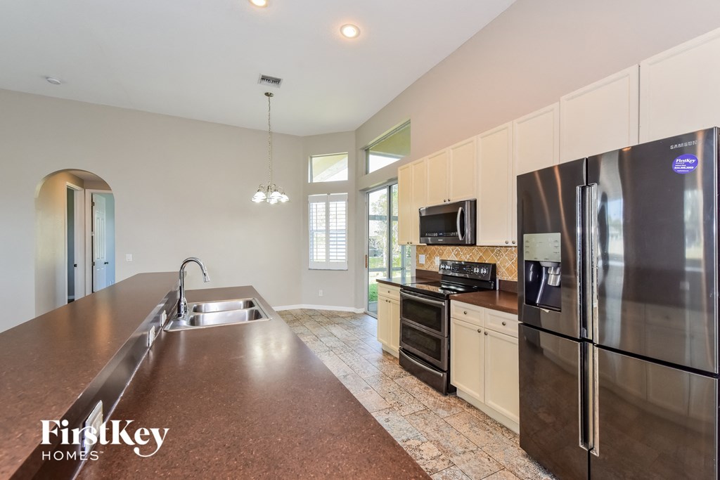 a large kitchen with stainless steel appliances and a large counter top
