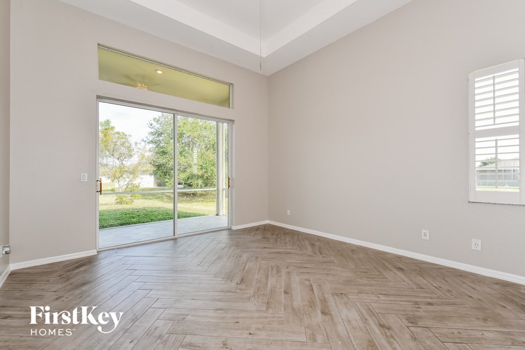 the living room with hardwood flooring and sliding glass doors to the backyard