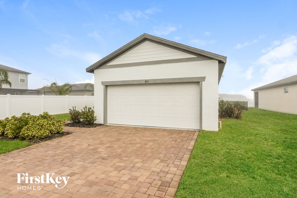 a garage with a garage door on a brick driveway