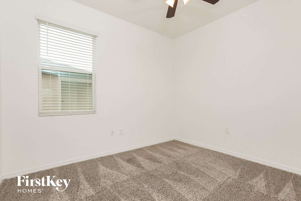 the living room of a home with carpet and a window