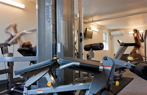 a man is working out in a gym with weights