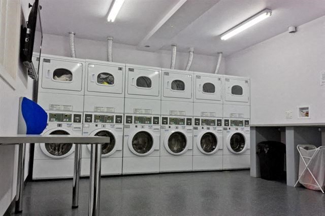 a row of washing machines in a laundry room