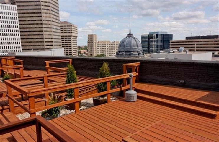 a wooden deck with a city skyline in the background