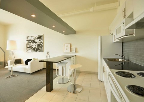 a kitchen and a living room with a counter top
