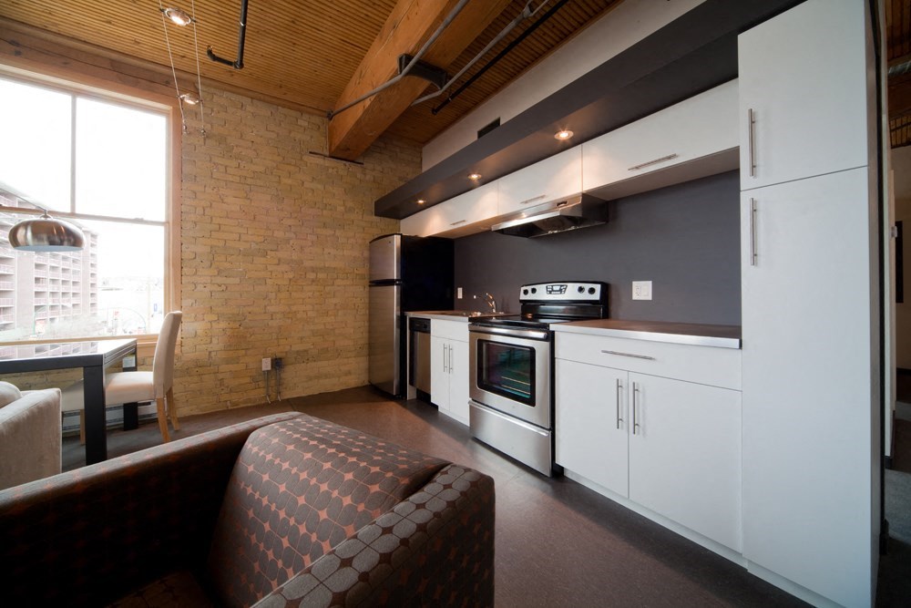 a kitchen with white cabinets and a stove top oven