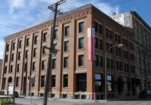 a large brick building on the corner of a street