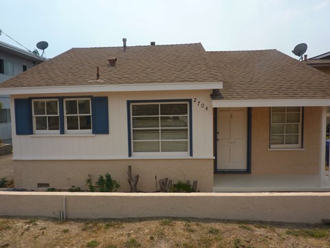 the front of the house has been remodeled with new windows and a roof