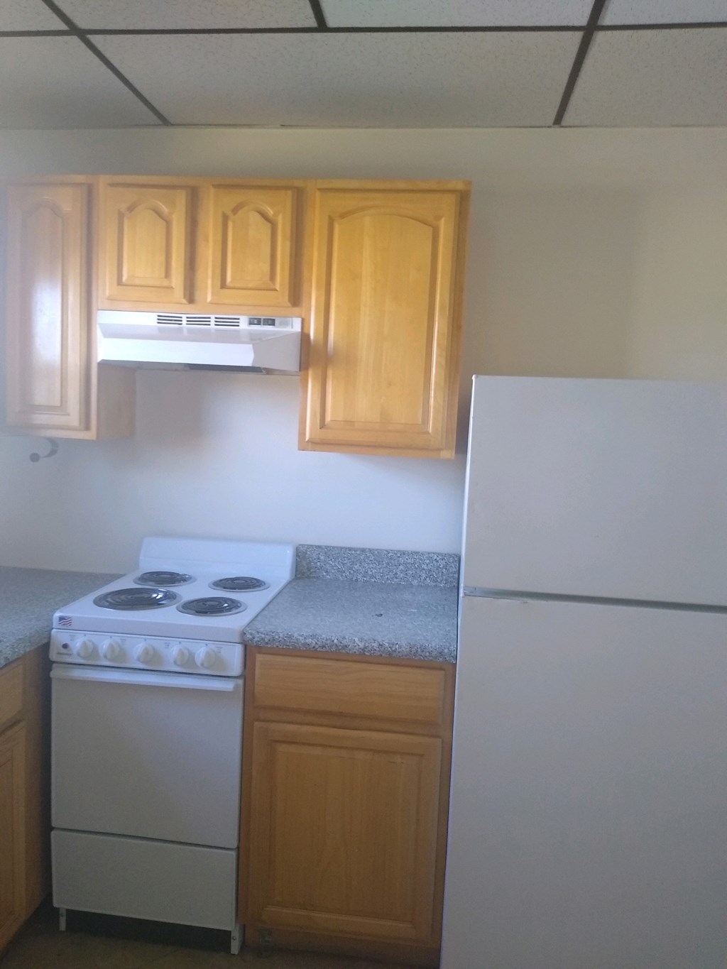 A small kitchen with a stove and a refrigerator.