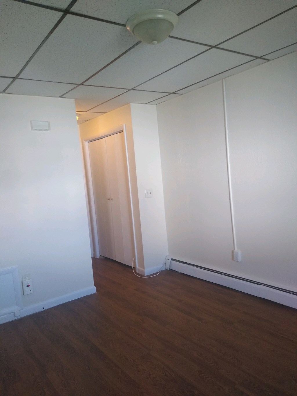 A room with a wooden floor and a door.