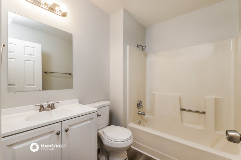 a bathroom with a sink toilet and a tub
