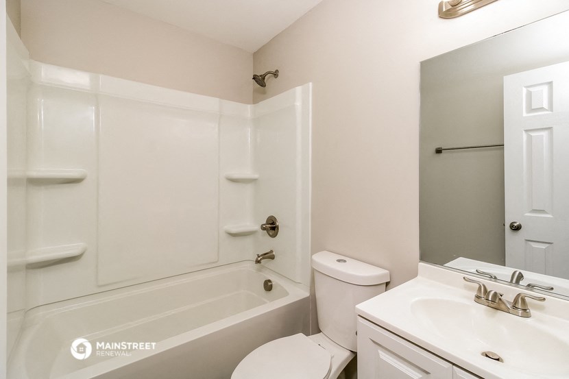 a bathroom with a sink toilet and a bath tub