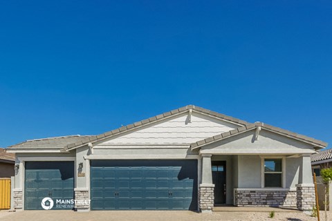 a house with a garage and a blue sky