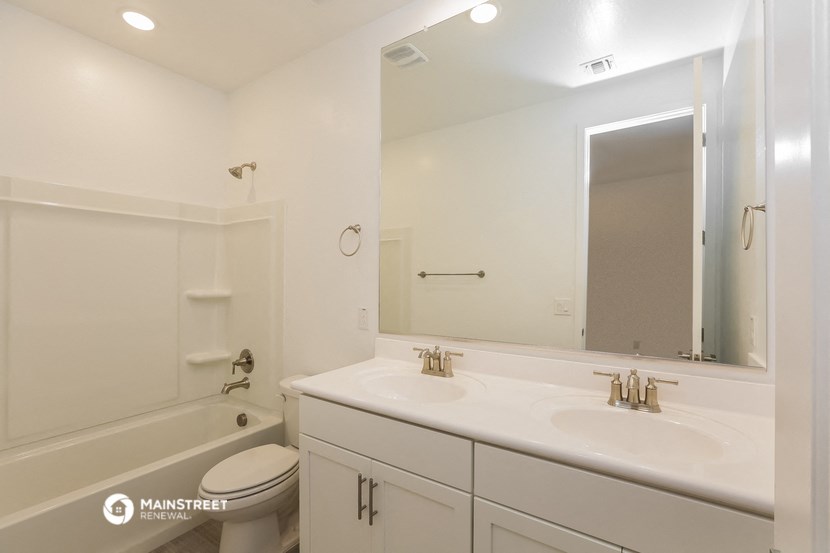 a bathroom with a sink and a toilet and a mirror