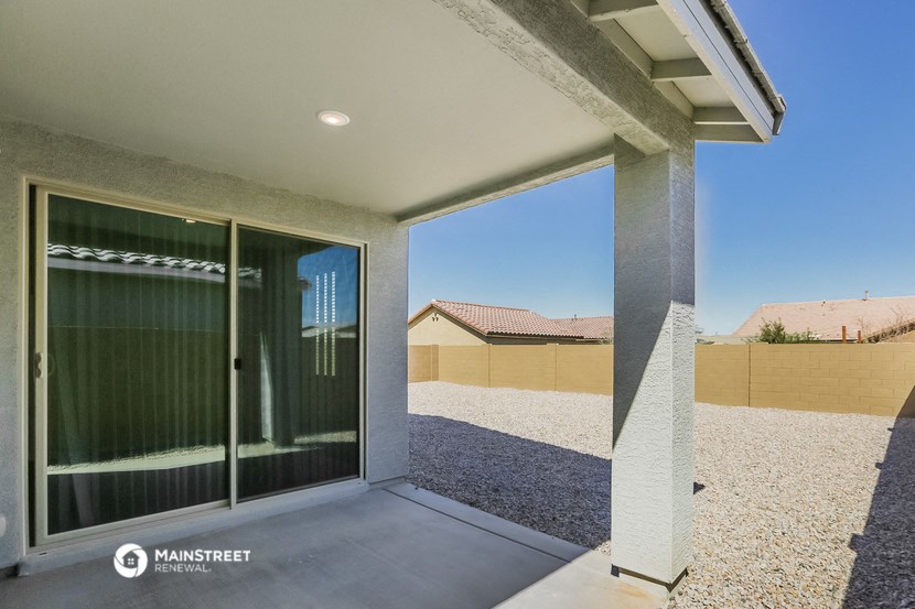 a patio with a glass door and a desert view