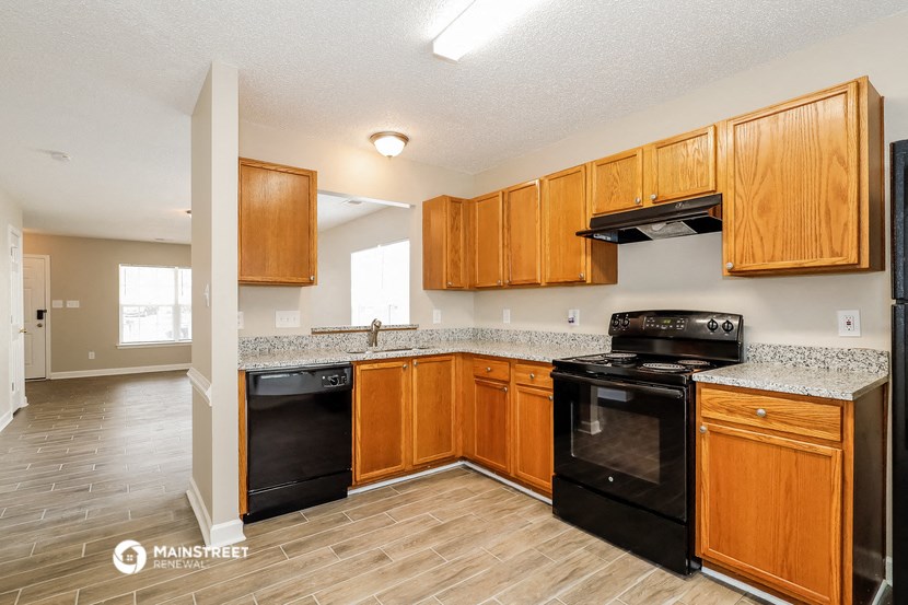 a kitchen with black appliances and wooden cabinets
