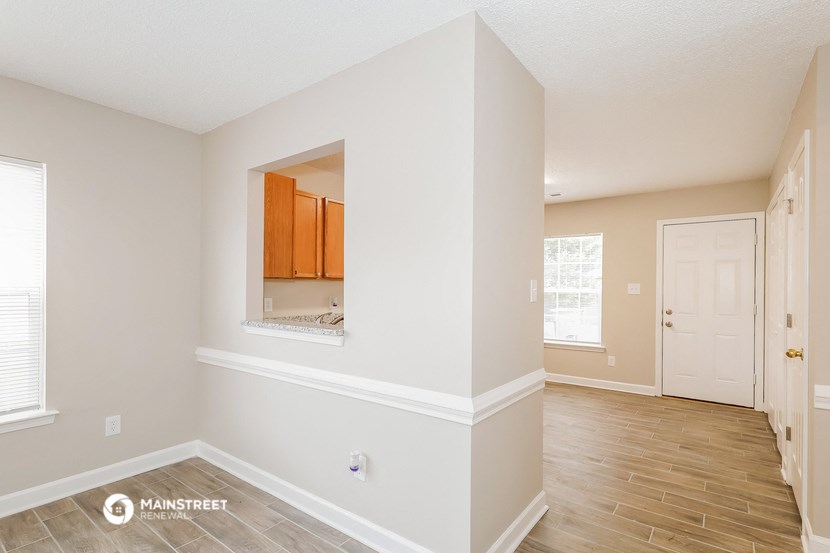the living room and dining room of an apartment
