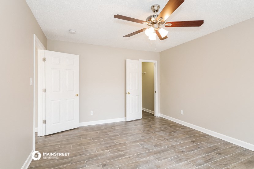 the living room of a new home with a ceiling fan