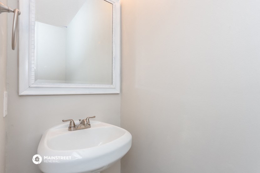 a small bathroom with a sink and a mirror