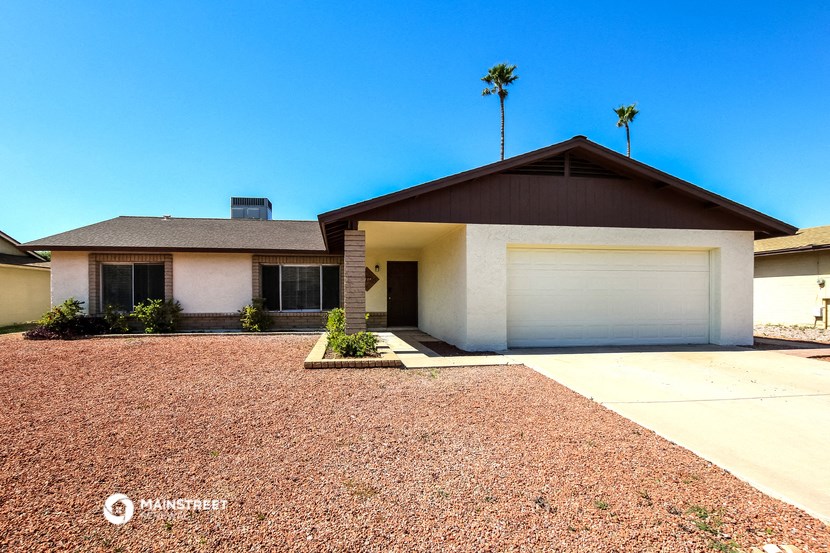 a white house with a driveway and a garage door