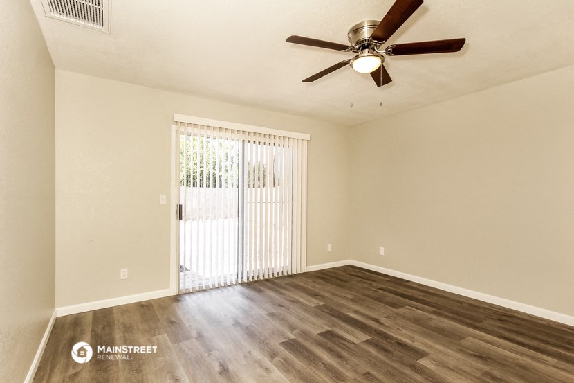 the spacious living room with sliding glass doors to the patio