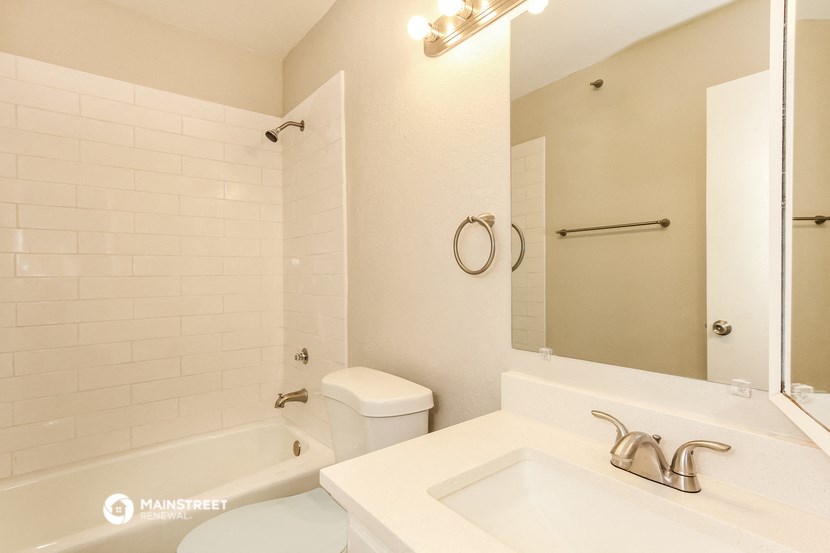 a bathroom with a sink and a toilet and a tub