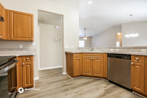a kitchen with wooden cabinets and stainless steel appliances