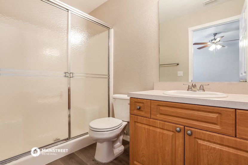 a bathroom with a shower toilet and sink