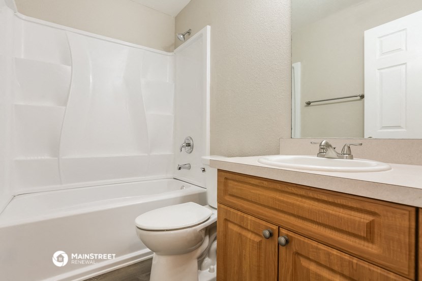 a bathroom with a sink toilet and a bath tub
