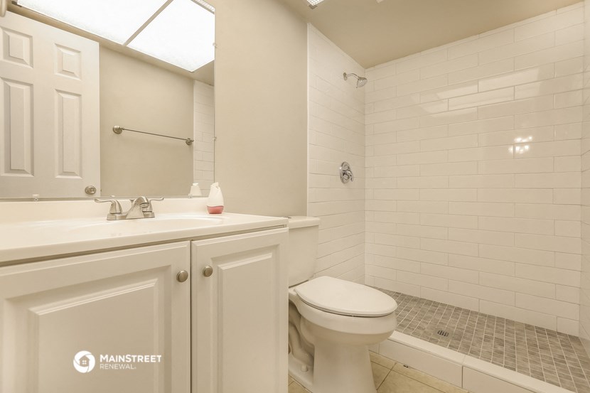 a white bathroom with a sink toilet and shower