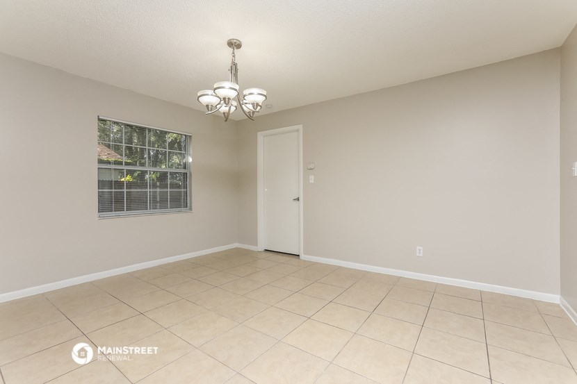 the living room of a house with a large tiled floor