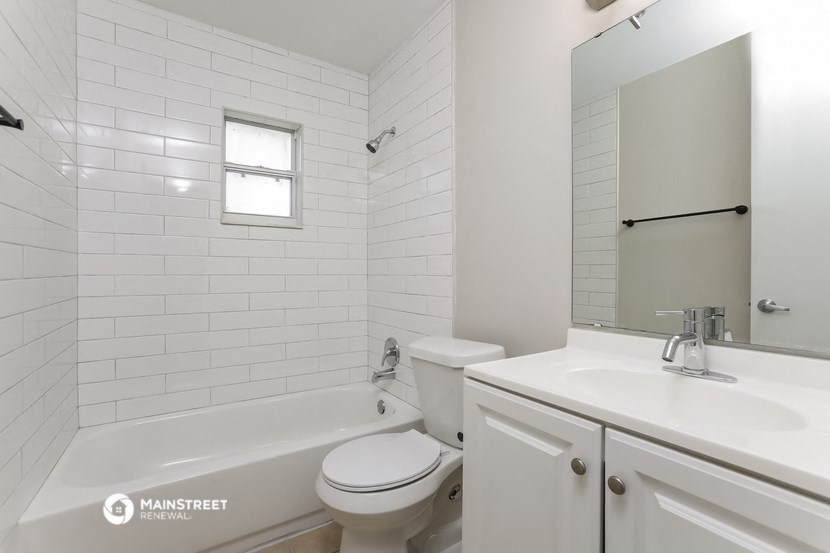 a white bathroom with a sink toilet and tub