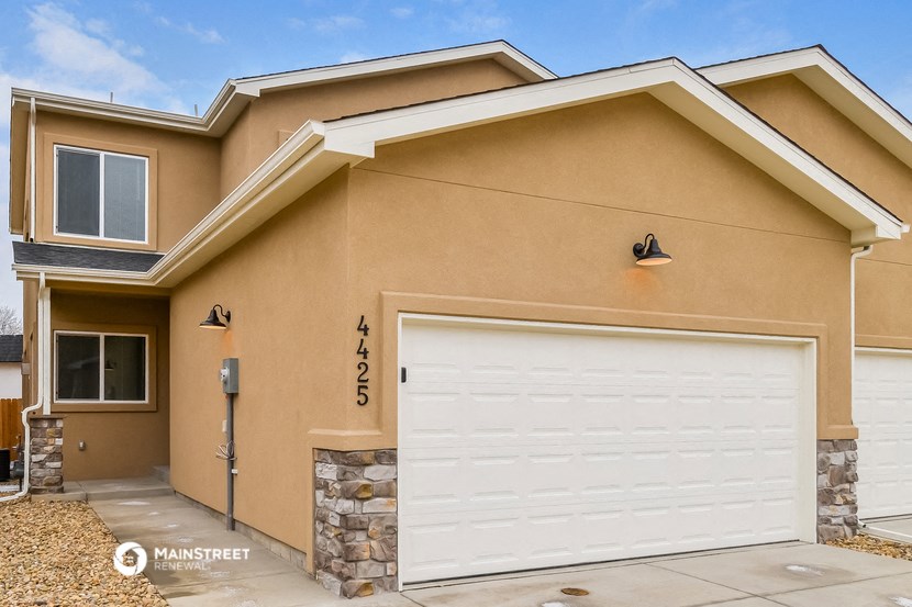 a house with a white garage door in front of it