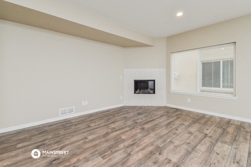 the living room has a fireplace and a large window