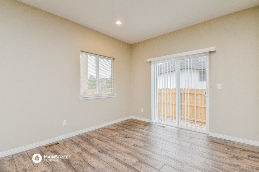 the living room of a new home with a sliding glass door