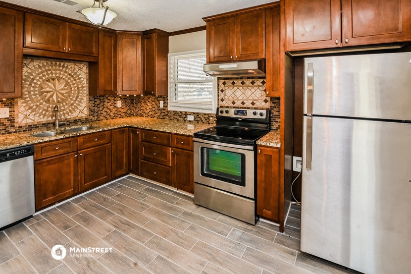 a kitchen with stainless steel appliances and wooden cabinets