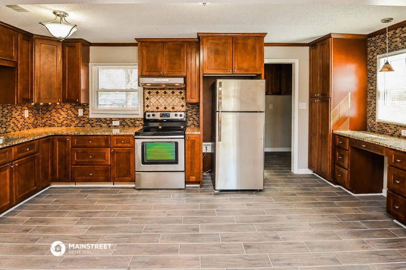 a kitchen with wooden cabinets and stainless steel appliances