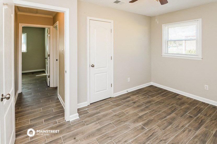 the living room and dining room of a house with wood flooring