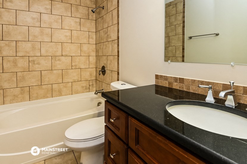 a bathroom with a sink and a toilet and a tub