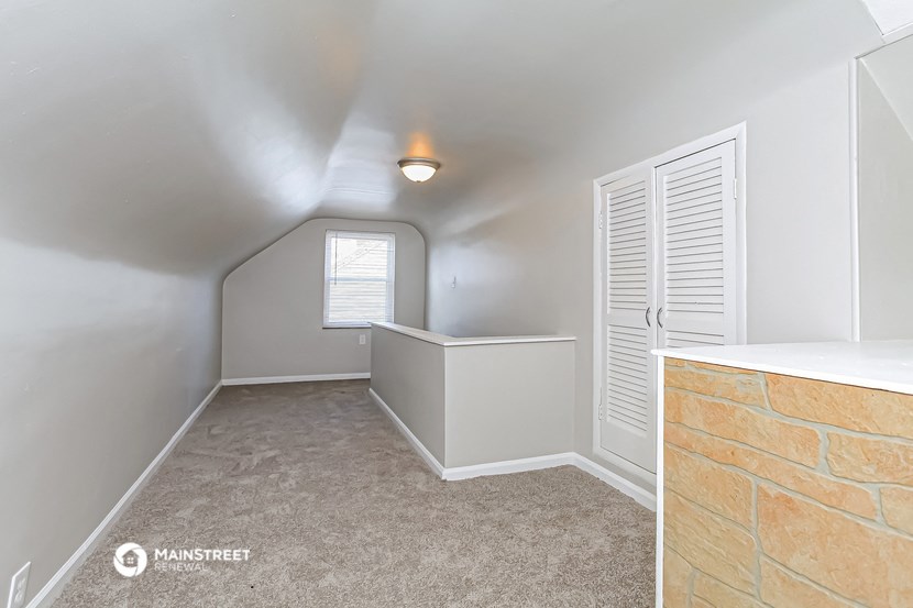 the upstairs laundry room has a counter top and a window