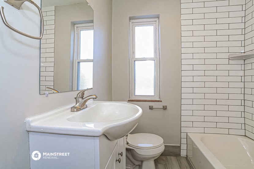 a white bathroom with a sink and a toilet